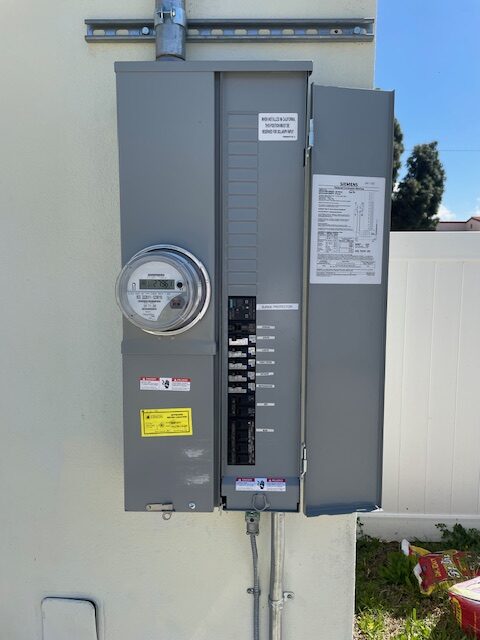 Ready Electric electrician inspecting a residential electrical panel for breaker replacement in Los Angeles